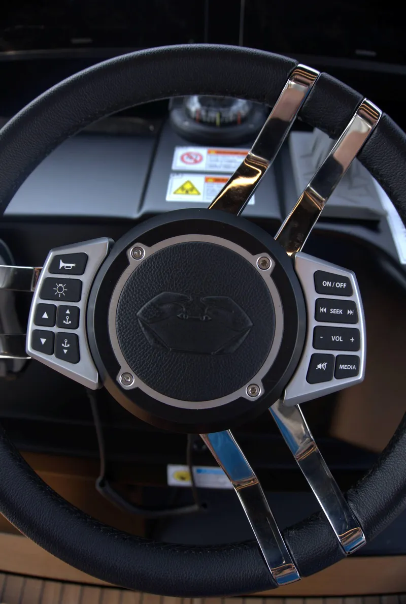 Slide: The Image of Steering wheel of 2024 Cranchi A46 yacht with control buttons. - 15