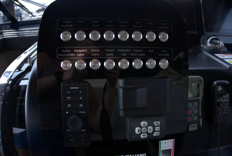 Slide: The Image of Control panel of 2024 Cranchi A46 yacht with various switches and navigation instruments. - 17