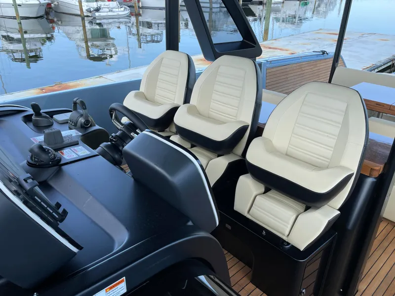 Slide: The Image of 2023 Cranchi A46 boat cockpit with three luxurious seats at the helm. - 20