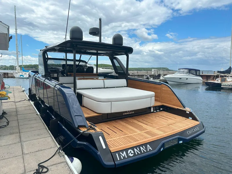 Slide: The Image of 2024 Cranchi A46 yacht docked, featuring sleek design and spacious deck in a marina setting. - 3