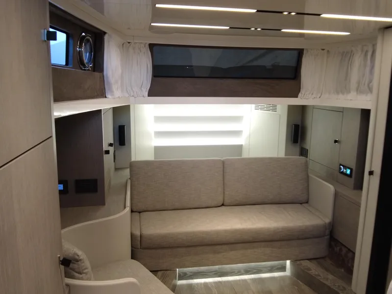 Slide: The Image of Modern interior of 2023 Cranchi A46 yacht with beige seating and ambient lighting. - 34