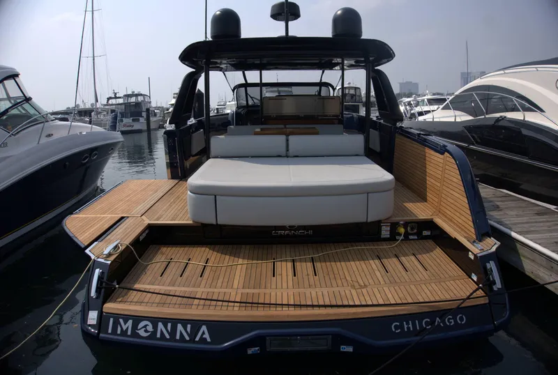 Slide: The Image of 2024 Cranchi A46 yacht docked in Chicago marina, featuring spacious deck and modern design. - 4