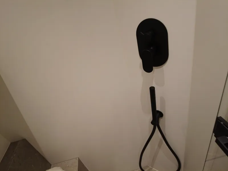 Slide: The Image of Black shower fixture in a modern bathroom on a 2024 Cranchi A46 yacht. - 48