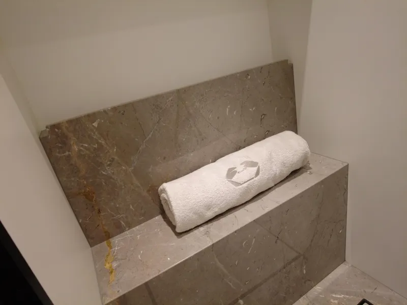 Slide: The Image of Luxurious marble interior of 2024 Cranchi A46 yacht with rolled towel. - 49