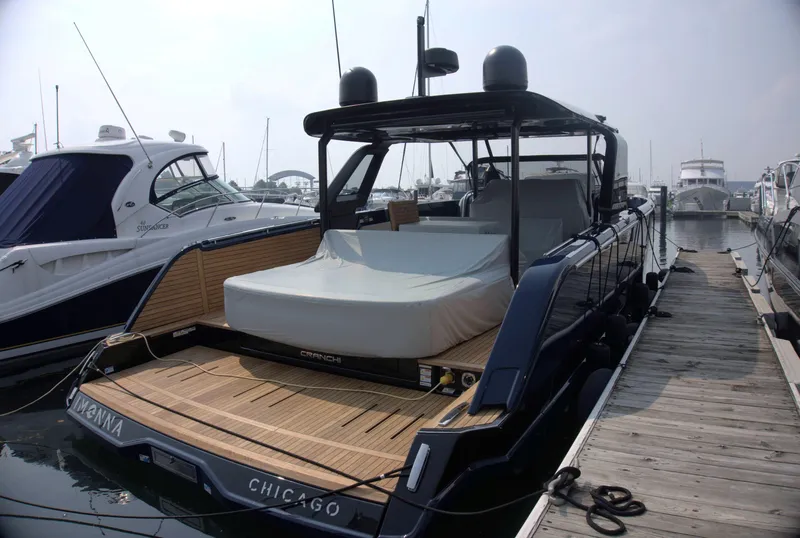 Slide: The Image of 2024 Cranchi A46 yacht docked at marina, featuring sleek design and spacious deck. - 6
