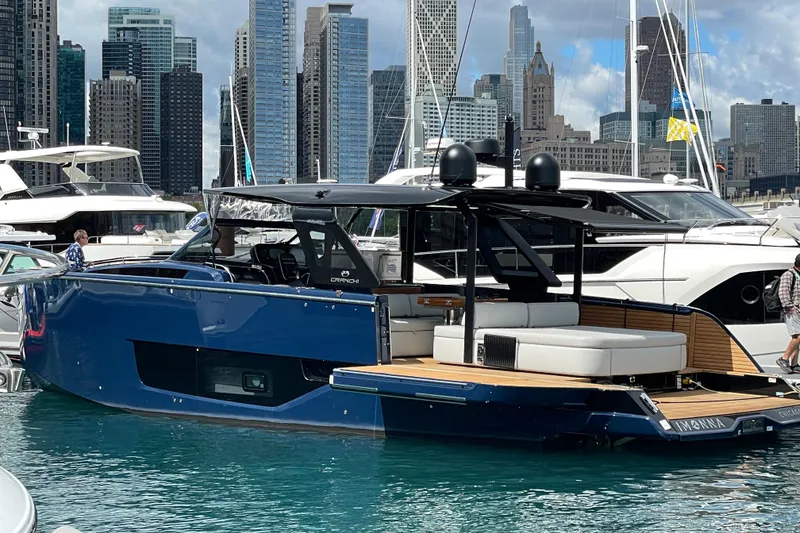 Slide: The Image of 2024 Cranchi A46 yacht docked in marina with city skyline backdrop. - 66