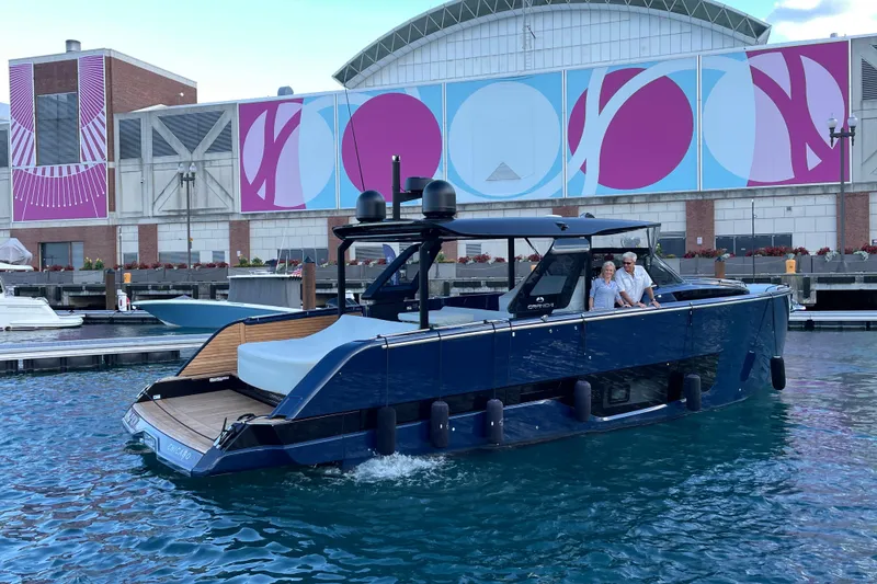Slide: The Image of 2024 Cranchi A46 yacht docked near colorful mural, featuring sleek design and modern amenities. - 69