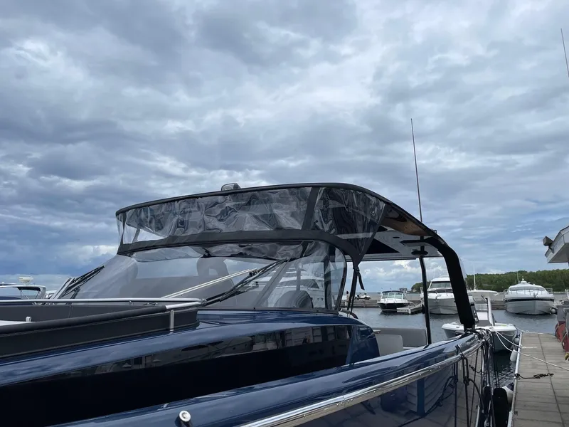 Slide: The Image of 2024 Cranchi A46 yacht docked under cloudy skies. - 7