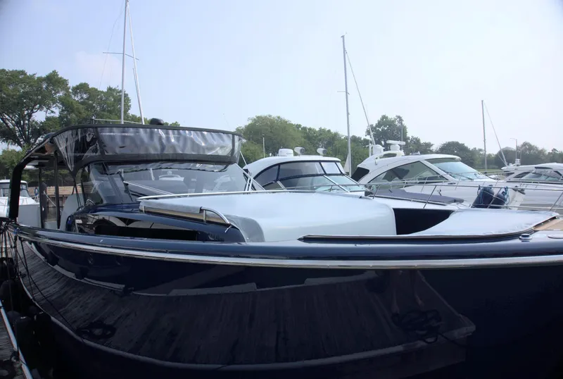 Slide: The Image of 2024 Cranchi A46 yacht docked at marina, sleek design, surrounded by other boats. - 8