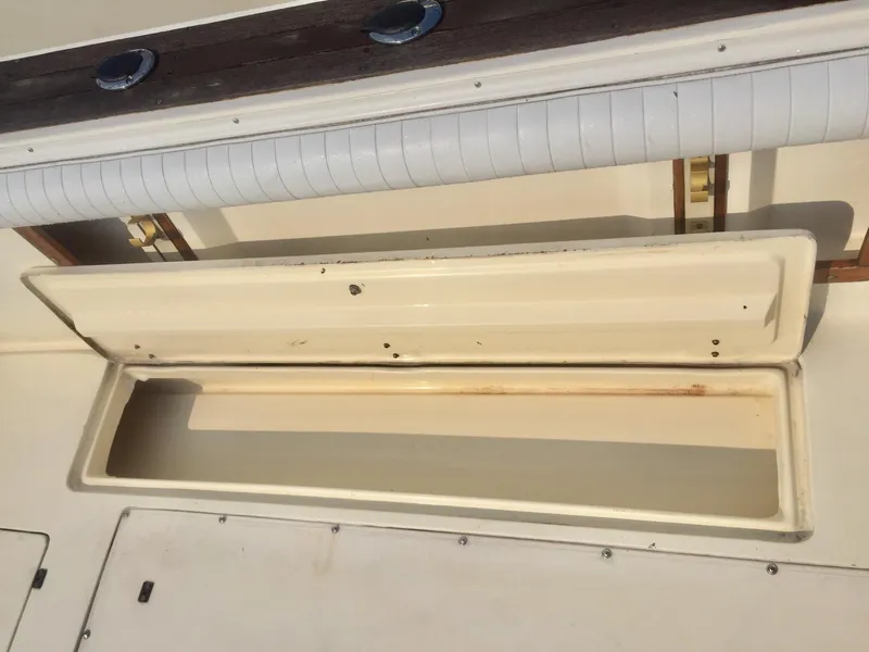 Slide: The Image of Open storage compartment on a 1991 Mako 260 Walk Around boat. - 13