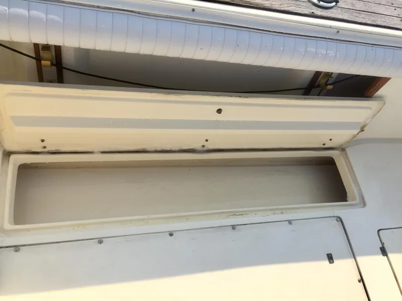 Slide: The Image of Open storage compartment on a 1991 Mako 260 Walk Around boat. - 14