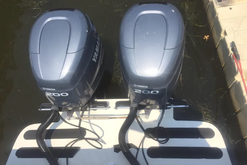 Slide: The Image of Twin Yamaha 200 outboard motors on a 1991 Mako 260 Walk Around boat. - 5