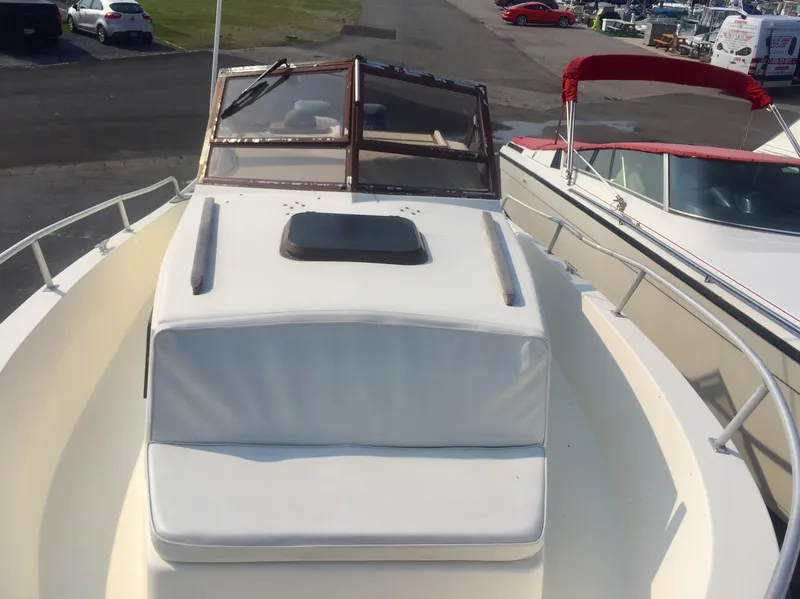 Slide: The Image of 1991 Mako 260 Walk Around boat with white deck and windshield. - 7