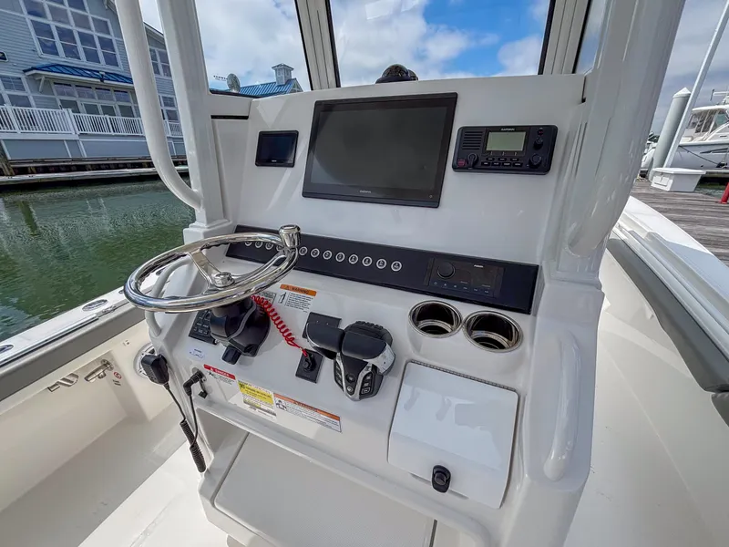 Slide: The Image of 2025 Regulator 23 boat console with steering wheel, navigation screen, and controls. - 11