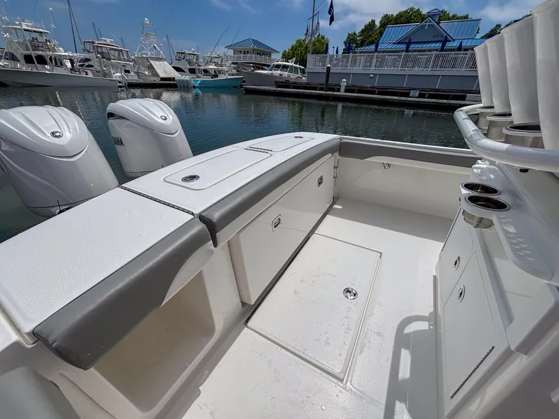 Slide: The Image of 2025 Regulator 23 boat interior with dual engines, docked at marina. - 12