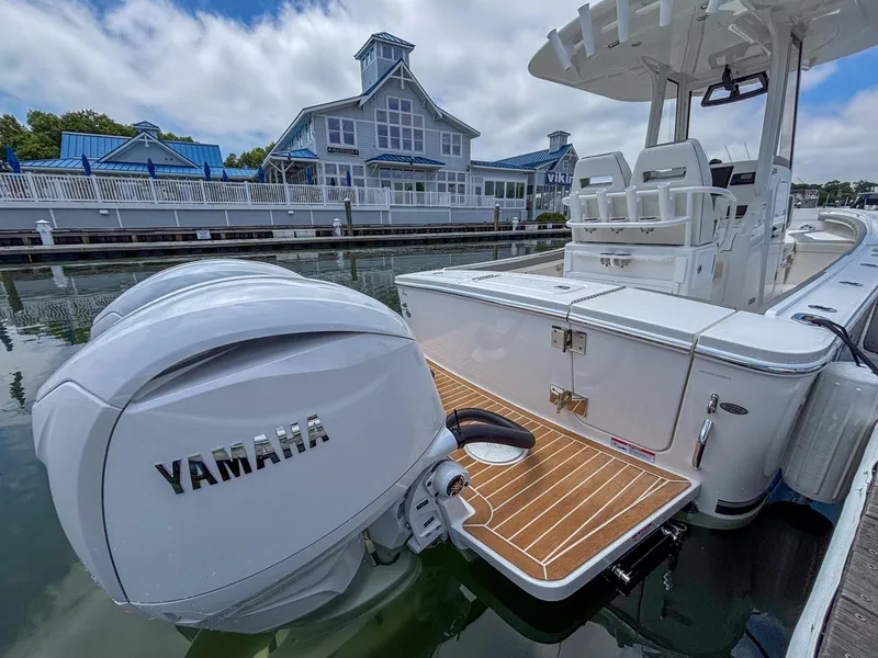 Slide: The Image of 2025 Regulator 23 boat with Yamaha engine docked near waterfront building. - 19