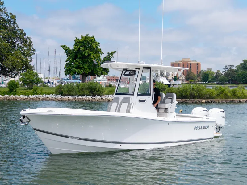 Slide: The Image of 2025 Regulator 23 boat on water, featuring sleek design and modern amenities. - 2