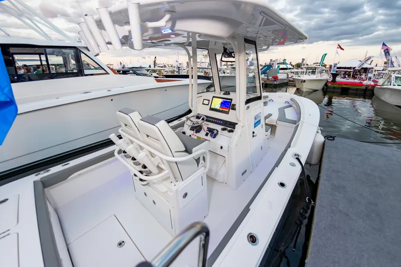 Slide: The Image of 2025 Regulator 23 boat interior at marina, featuring modern helm and seating. - 23
