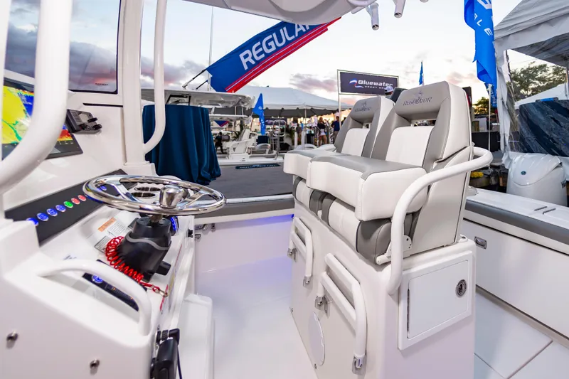 Slide: The Image of 2025 Regulator 23 boat interior with dual seats and modern steering console. - 27