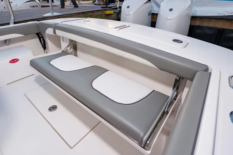 Slide: The Image of 2025 Regulator 23 boat with gray and white cushioned seating, showcasing modern design. - 31