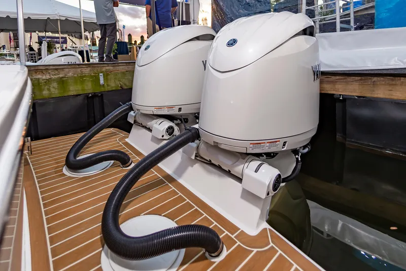 Slide: The Image of 2025 Regulator 23 boat with dual Yamaha outboard engines at a dock. - 34