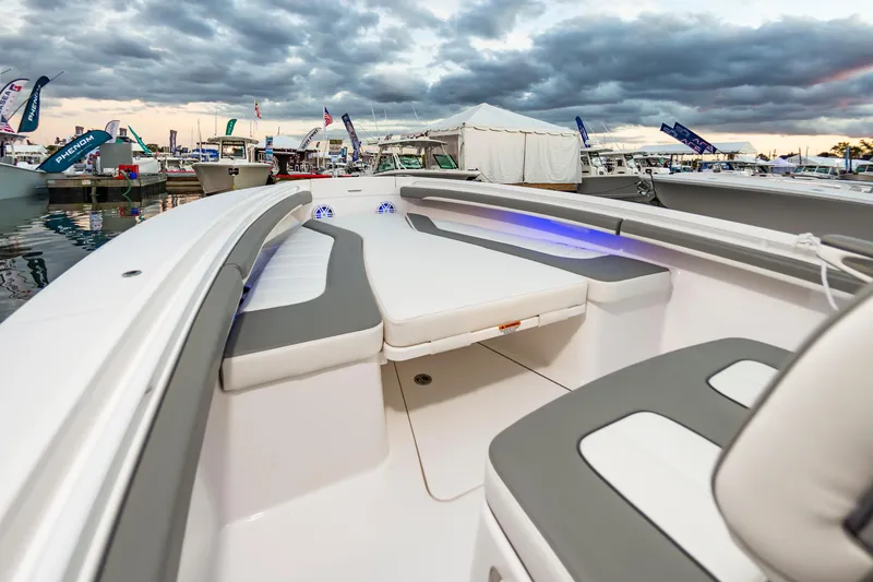 Slide: The Image of 2025 Regulator 23 boat interior at marina, featuring sleek seating and modern design. - 35