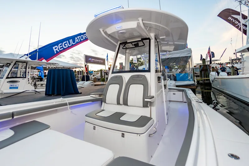Slide: The Image of 2025 Regulator 23 boat at a marina, showcasing sleek design and modern features. - 36