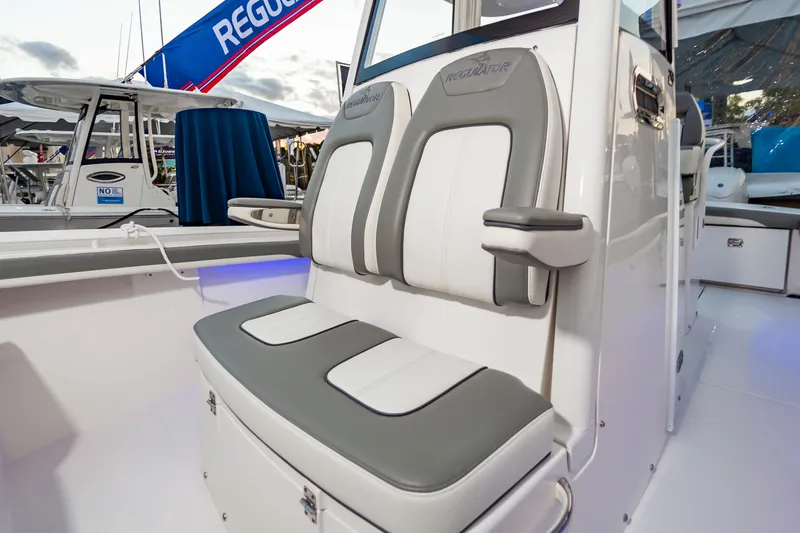 Slide: The Image of 2025 Regulator 23 boat interior with cushioned seating and sleek design. - 38