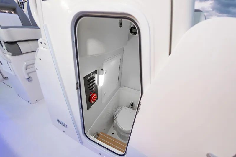 Slide: The Image of 2025 Regulator 23 boat interior with open storage compartment and control panel. - 39