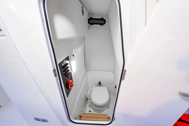 Slide: The Image of 2025 Regulator 23 boat interior with compact marine toilet and control panel. - 40