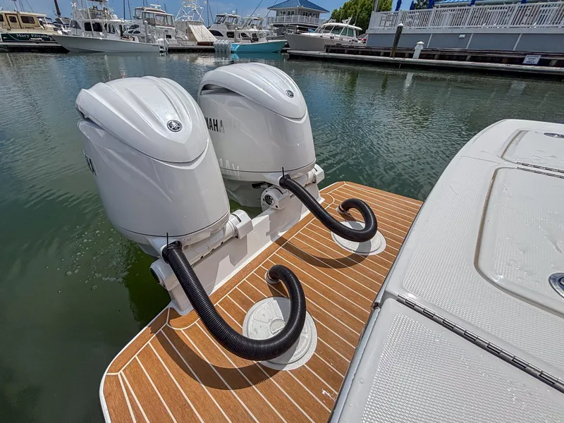 Slide: The Image of Twin Yamaha outboard motors on 2025 Regulator 23 boat, docked in marina. - 8