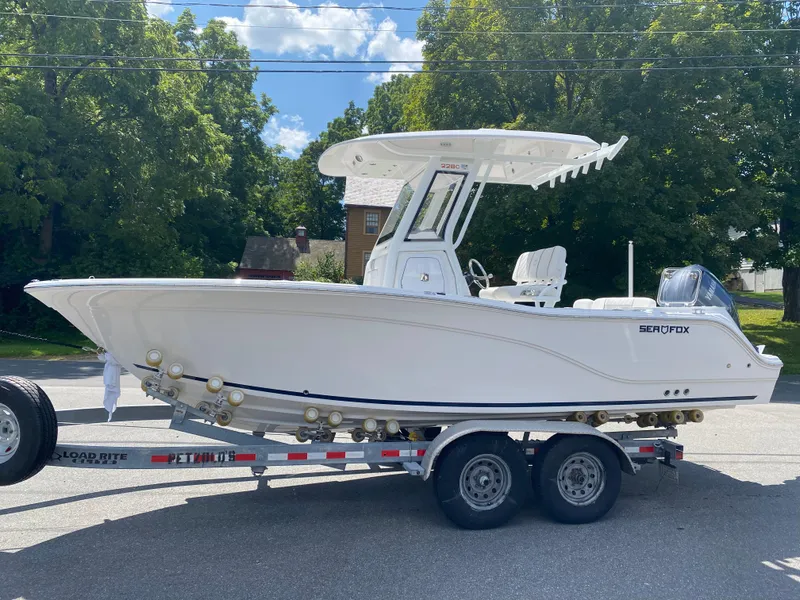 Slide: The Image of 2025 Sea Fox 228 Commander boat on trailer, parked outdoors. - 1