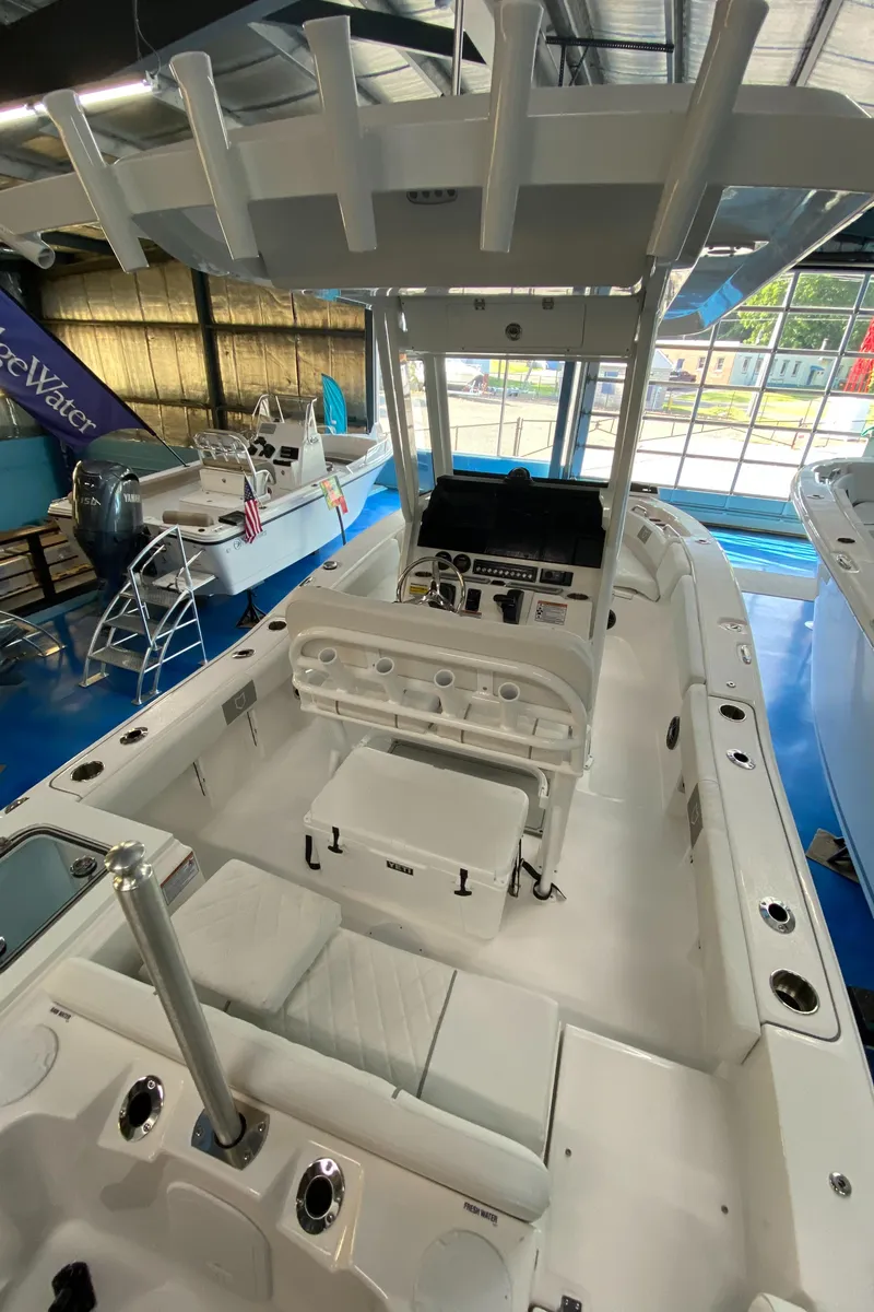 Slide: The Image of 2025 Sea Fox 228 Commander boat interior with seating and console in showroom. - 10