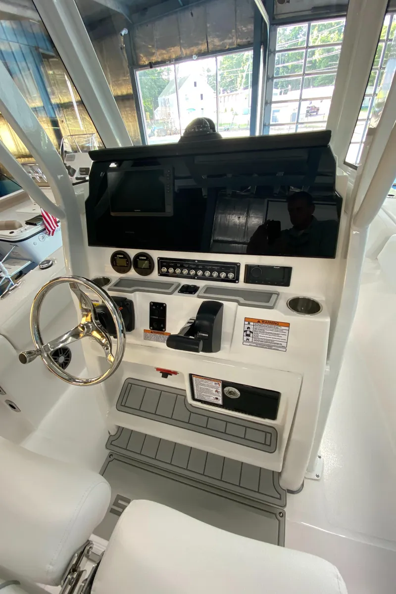 Slide: The Image of 2025 Sea Fox 228 Commander boat dashboard with steering wheel and controls. - 11