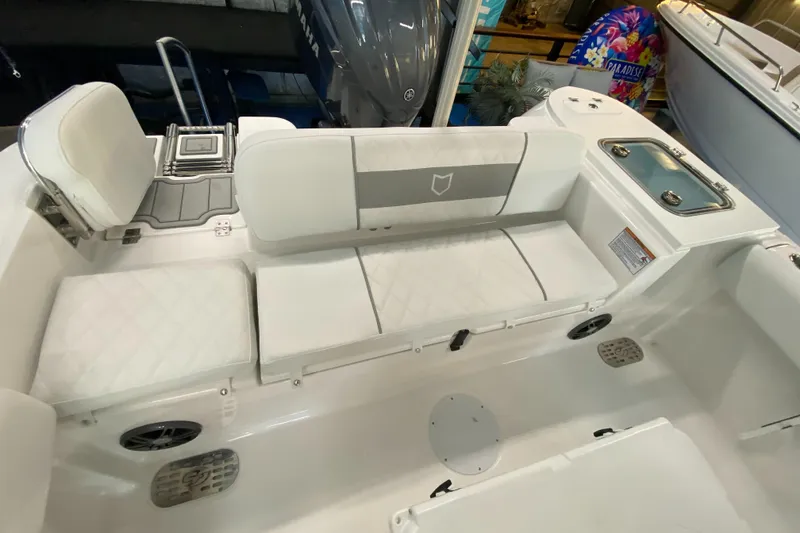 Slide: The Image of Interior view of 2025 Sea Fox 228 Commander boat with white seating and storage. - 12