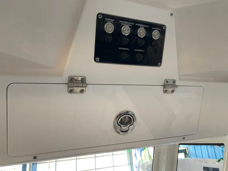 Slide: The Image of 2025 Sea Fox 228 Commander dashboard with control panel and storage compartment. - 16