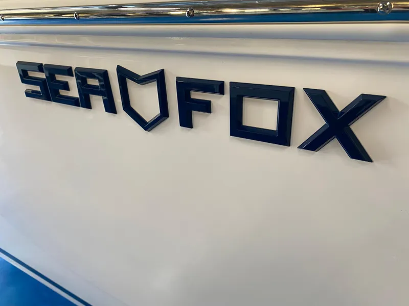 Slide: The Image of Sea Fox 228 Commander 2025 boat logo on white hull. - 24