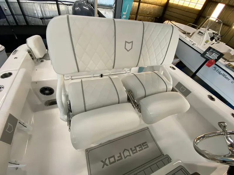 Slide: The Image of 2025 Sea Fox 228 Commander boat interior with white cushioned seating. - 7