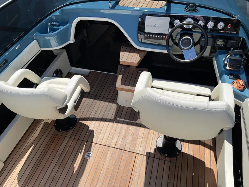 Slide: The Image of 2022 Cranchi 26 Classic boat interior with leather seats and wooden flooring. - 10