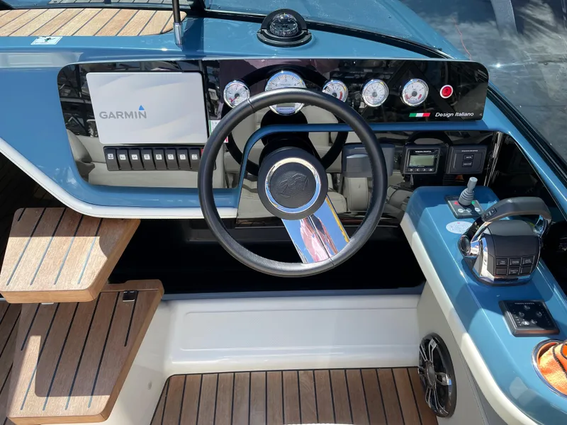 Slide: The Image of Cranchi 26 Classic 2022 boat dashboard with Garmin navigation system and wooden steps. - 12