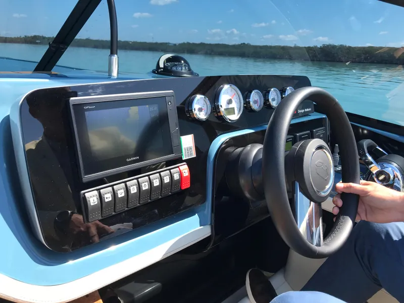 Slide: The Image of Control panel of a 2022 Cranchi 26 Classic boat on a calm lake. - 13