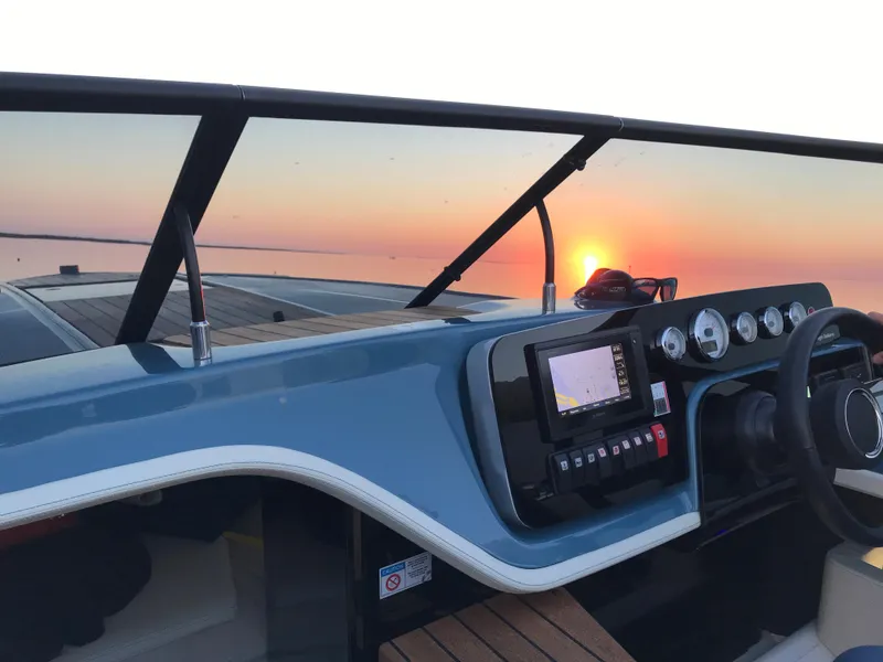 Slide: The Image of 2022 Cranchi 26 Classic boat dashboard at sunset. - 14