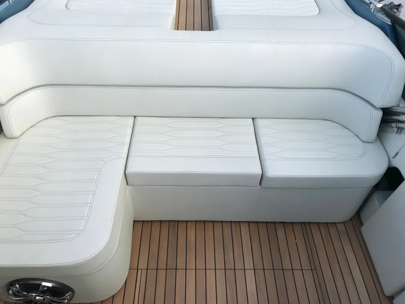 Slide: The Image of Cranchi 26 Classic 2022 boat interior with white leather seating and wooden flooring. - 18