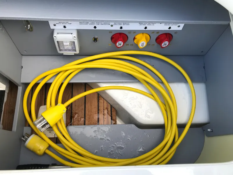 Slide: The Image of Yellow power cable in the electrical compartment of a 2022 Cranchi 26 Classic boat. - 19
