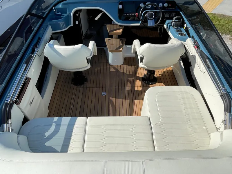 Slide: The Image of Interior of 2022 Cranchi 26 Classic boat with white seating and wooden flooring. - 20
