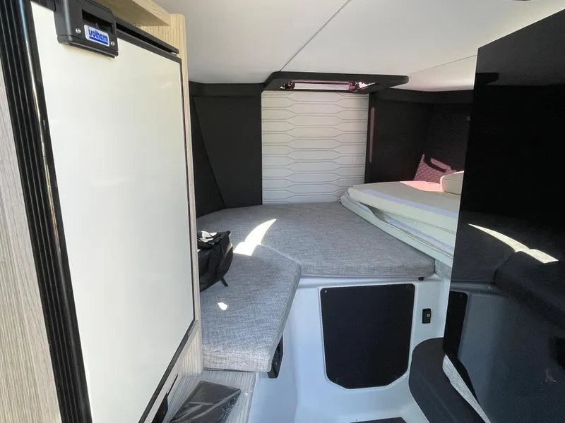 Slide: The Image of Interior cabin of 2022 Cranchi 26 Classic boat with bed and compact fridge. - 23