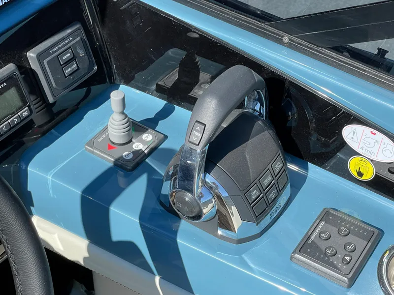 Slide: The Image of Control panel of a 2022 Cranchi 26 Classic boat with throttle and joystick. - 24