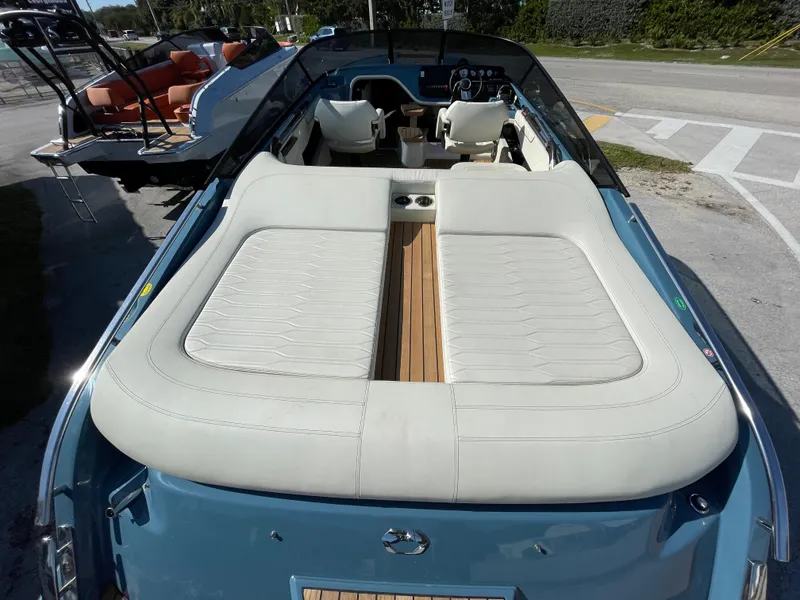 Slide: The Image of 2022 Cranchi 26 Classic boat with white leather seating and blue exterior. - 29