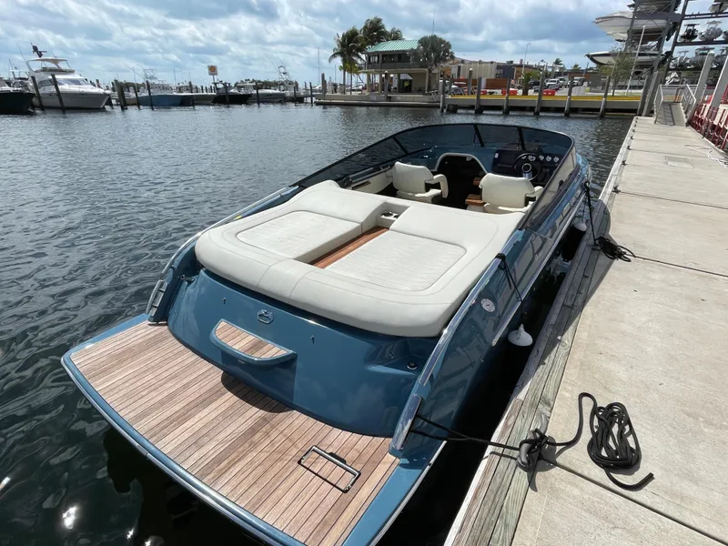 Slide: The Image of 2022 Cranchi 26 Classic boat docked at marina, featuring sleek design and spacious seating. - 6