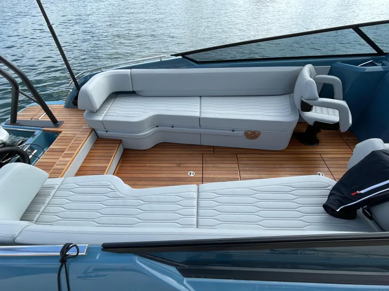 Slide: The Image of 2022 Cranchi 26 Rider boat interior with luxurious seating and wooden deck. - 28